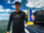 Swiss skipper oliver Heer holding AirMarkerAG R.Four whilst stood on yacht